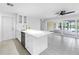 Modern kitchen featuring a center island, sliding glass doors, and sleek, neutral finishes at 2146 Egret Drive, Clearwater, FL 33764