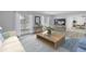 Bright living room with light wood floors, large windows, and modern, neutral furnishings at 2146 Egret Drive, Clearwater, FL 33764