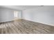 Spacious living room with modern wood-look floors and freshly painted white walls at 2146 Egret Drive, Clearwater, FL 33764