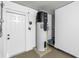 Water heater in mechanical room adjacent to a white door at 2146 Egret Drive, Clearwater, FL 33764
