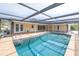 Inviting covered pool area with brick surround, perfect for outdoor relaxation and entertaining at 2146 Egret Drive, Clearwater, FL 33764