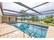 Screened-in pool with waterfront views and a brick deck at 2146 Egret Drive, Clearwater, FL 33764