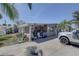 Exterior shot of a home with a covered carport and front yard featuring some desert landscaping at 265 115Th Ave, Treasure Island, FL 33706