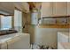 Functional laundry area features a washer, dryer, utility sink, and storage cabinets for convenience at 265 115Th Ave, Treasure Island, FL 33706