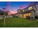 Lush backyard featuring a covered patio, verdant green lawn, and charming pergola structure at 2693 Leafwing Ct, Palm Harbor, FL 34683