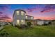 Spacious backyard featuring a covered patio, lush green lawn, and well-maintained landscaping at 2693 Leafwing Ct, Palm Harbor, FL 34683
