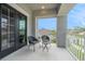 Balcony offers comfortable seating with 2 chairs and a small table overlooking neighborhood streets at 2693 Leafwing Ct, Palm Harbor, FL 34683