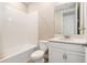 Clean bathroom featuring a white tub, toilet, vanity with light countertops, and a rectangular mirror at 2693 Leafwing Ct, Palm Harbor, FL 34683