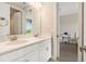 Elegant bathroom boasting double sinks, modern fixtures, and a view into the adjacent bedroom at 2693 Leafwing Ct, Palm Harbor, FL 34683