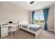 Cozy bedroom with natural light, featuring a desk, modern bed, and blue curtains at 2693 Leafwing Ct, Palm Harbor, FL 34683