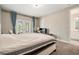 Spacious bedroom with French doors leading to a balcony with outside views at 2693 Leafwing Ct, Palm Harbor, FL 34683