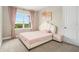 Bright bedroom featuring a white scallop headboard and soft, natural light at 2693 Leafwing Ct, Palm Harbor, FL 34683
