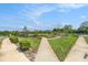 A view of the beautiful, lush community grounds showcasing mature trees and sidewalks at 2693 Leafwing Ct, Palm Harbor, FL 34683
