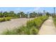 Gated entrance to the community with manicured landscaping offers both security and curb appeal at 2693 Leafwing Ct, Palm Harbor, FL 34683