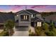 Modern two-story home featuring gray stucco exterior with a balcony and well-maintained landscaping at 2693 Leafwing Ct, Palm Harbor, FL 34683