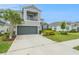 Charming two-story home with a balcony, a well-manicured lawn, and vibrant landscaping at 2693 Leafwing Ct, Palm Harbor, FL 34683