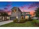 Charming two-story home featuring a balcony, a well-manicured lawn, and a two-car garage at 2693 Leafwing Ct, Palm Harbor, FL 34683