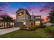 Stunning two-story home with a balcony, a two-car garage, and a lush, landscaped front yard at 2693 Leafwing Ct, Palm Harbor, FL 34683