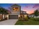 Beautiful two-story home with a balcony, a two-car garage, and a well-manicured front lawn at 2693 Leafwing Ct, Palm Harbor, FL 34683