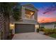 Attractive two-story home with a balcony, attached two-car garage, and meticulously landscaped front yard at 2693 Leafwing Ct, Palm Harbor, FL 34683