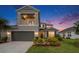 Charming two-story home featuring a balcony, well-maintained landscaping, and a two-car garage at 2693 Leafwing Ct, Palm Harbor, FL 34683