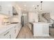 Bright, modern kitchen with white cabinets, stainless appliances, and a breakfast bar at 2693 Leafwing Ct, Palm Harbor, FL 34683