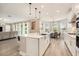 Spacious kitchen island with modern fixtures adjoins the sunny dining area and comfortable living space at 2693 Leafwing Ct, Palm Harbor, FL 34683