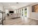 Bright living room with hardwood floors, large sectional couch and sliding glass doors at 2693 Leafwing Ct, Palm Harbor, FL 34683