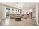 Spacious living room with hardwood floors, large sectional couch and sliding glass doors to the backyard at 2693 Leafwing Ct, Palm Harbor, FL 34683