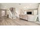 Open-concept floor plan with spacious living room and staircase with gray accents at 2693 Leafwing Ct, Palm Harbor, FL 34683