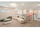 Bright living room featuring a comfortable sofa, unique seating, and contemporary decor at 2693 Leafwing Ct, Palm Harbor, FL 34683