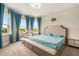 Bright and airy main bedroom with large windows, neutral decor, and a sitting area at 2693 Leafwing Ct, Palm Harbor, FL 34683