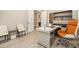 Bright home office featuring modern desk, built-in shelving and an adjustable ergonomic chair at 2693 Leafwing Ct, Palm Harbor, FL 34683