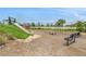 Community playground featuring a slide, seating, and climbing structure in a landscaped setting at 2693 Leafwing Ct, Palm Harbor, FL 34683