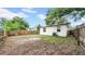 The backyard is surrounded by a wood fence and mature trees at 2921 N 18Th St, Tampa, FL 33605