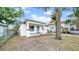 Charming single-story home with a blue front door, a covered porch, and mature trees at 2921 N 18Th St, Tampa, FL 33605