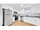 Modern kitchen features stainless steel appliances, granite countertops and white cabinets at 2921 N 18Th St, Tampa, FL 33605