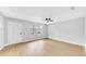 Bright and airy living room featuring wood flooring and a contemporary ceiling fan at 2921 N 18Th St, Tampa, FL 33605
