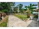 Lush backyard with green grass and mature trees, offering a private outdoor retreat at 306 Banana St, Tarpon Springs, FL 34689