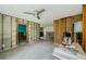 Unfinished living room with concrete floors, ceiling fan and open doorway to another room at 306 Banana St, Tarpon Springs, FL 34689