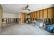 A spacious, unfinished living room with concrete floors, and a ceiling fan at 306 Banana St, Tarpon Springs, FL 34689