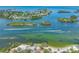 Expansive aerial view of the waterfront, showcasing picturesque islands, clear waters, and boating paradise at 3072 Inlet Breeze Way, Holiday, FL 34691