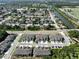 An aerial view of a neighborhood near a canal and surrounding green areas at 3072 Inlet Breeze Way, Holiday, FL 34691