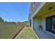 Backyard features a fenced-in yard with a patio and green grass at 3072 Inlet Breeze Way, Holiday, FL 34691