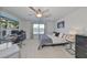 Well-lit bedroom with ceiling fan and large window, offering a view and desk space for work or study at 3072 Inlet Breeze Way, Holiday, FL 34691