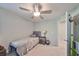Bedroom featuring a single bed, nightstand and an open closet with ceiling fan at 3072 Inlet Breeze Way, Holiday, FL 34691