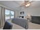 Bright bedroom with a ceiling fan and view from the window with closet and room for furniture and personalization at 3072 Inlet Breeze Way, Holiday, FL 34691