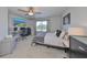 Bright bedroom featuring a ceiling fan, a large window, and dedicated desk space at 3072 Inlet Breeze Way, Holiday, FL 34691