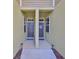 Shared walkway between townhomes, front doors with decorative wreaths at 3072 Inlet Breeze Way, Holiday, FL 34691