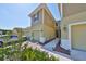 Townhome exterior with a two-car garage, neutral paint, and manicured landscaping at 3072 Inlet Breeze Way, Holiday, FL 34691